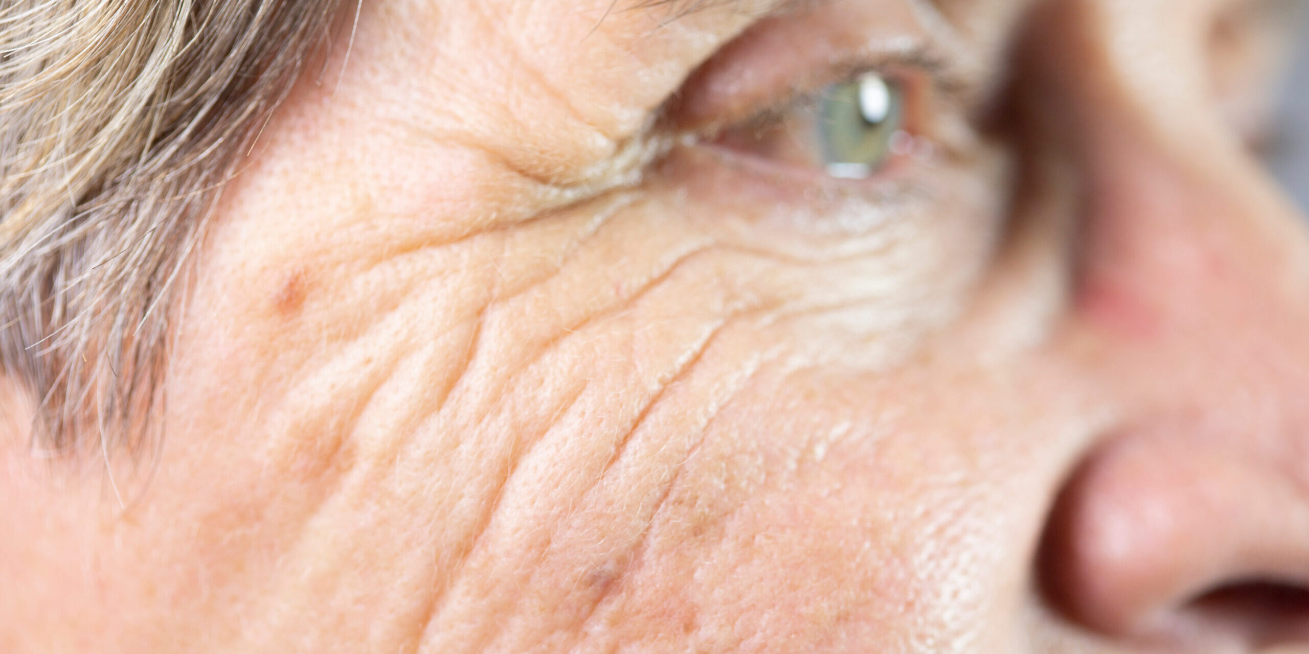 Close up of males face with crows feet by eyes